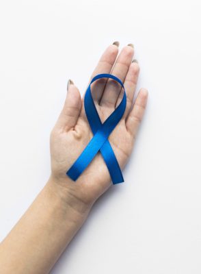 crop-hand-with-colon-cancer-ribbon